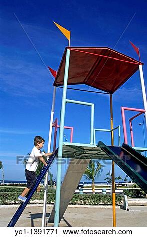 Young boy on a slide in a playground, Campeche, Mexico View Large Photo Image Stock Image - Young boy on a slide in a playground, Campeche, Mexico. Fotosearch