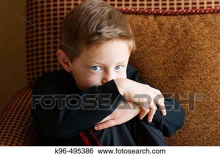 young boy on cushion chair View Large Photo Image Stock Photograph - young boy on cushion chair. Fotosearch