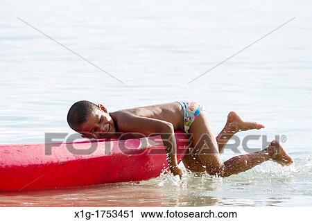 Young boy playing in the ocean at Starfish beach on Isla Colon, Bocas del Toro, Panama View Large Photo Image Stock Image - Young boy playing in the ocean at Starfish beach on Isla Colon, Bocas del Toro, Panama. Fotosearch