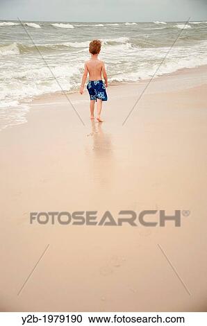 Young boy playing on sandy beach in Perdido Key Florida USA. View Large Photo Image Stock Image - Young boy playing on sandy beach in Perdido Key Florida USA.. Fotosearch