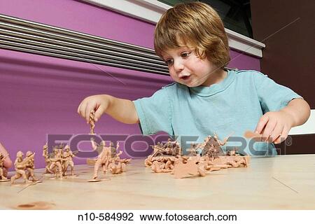 Young boy playing with plastic toy solders. View Large Photo Image Stock Image - Young boy playing with plastic toy solders.. Fotosearch