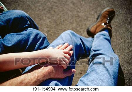Young boy putting his hand on his dad? s View Large Photo Image Picture - Young boy putting his hand on his dad? s. Fotosearch