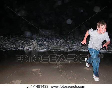 Young Boy running from wave View Large Photo Image Stock Image - Young Boy running from wave. Fotosearch