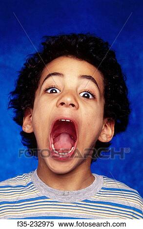 Stock Photography - Young boy screaming portrait. Fotosearch