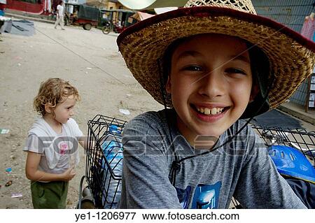 Young boy smiling for the camera in Fuli village in Yangshuo, Guangxi, China. View Large Photo Image Stock Photo - Young boy smiling for the camera in Fuli village in Yangshuo, Guangxi, China.. Fotosearch
