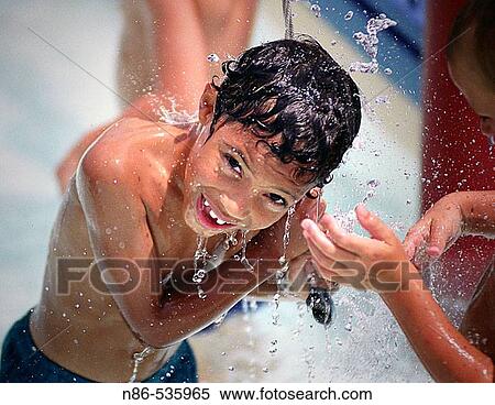 Young boy smiling in water View Large Photo Image Stock Photography - Young boy smiling in water. Fotosearch
