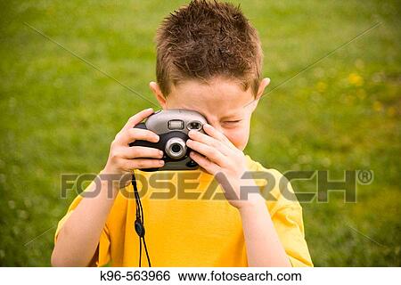 Young boy taking picture View Large Photo Image Stock Photograph - Young boy taking picture. Fotosearch