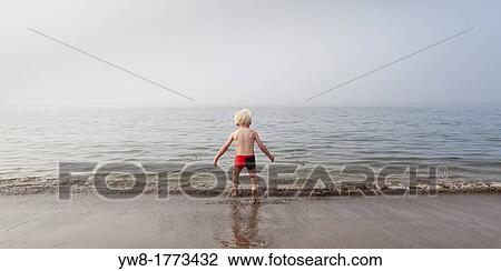 Young boy testing the cold waters, Akranes, Iceland View Large Photo Image Stock Image - Young boy testing the cold waters, Akranes, Iceland. Fotosearch