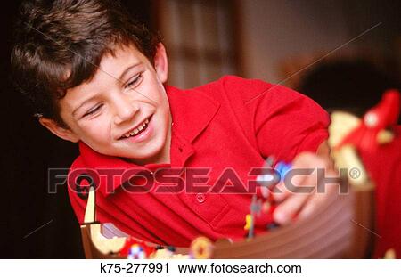Young boy using his imagination View Large Photo Image Stock Image - Young boy using his imagination. Fotosearch