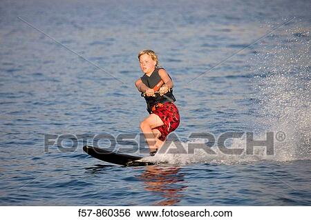 Young boy water skiing in the Mediterranean View Large Photo Image Stock Photograph - Young boy water skiing in the Mediterranean. Fotosearch
