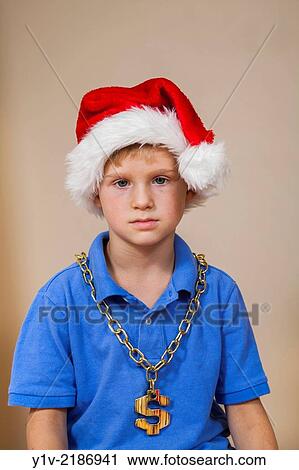 Young boy wearing a Santa hat and a US money symbol chain. View Large Photo Image Stock Image - Young boy wearing a Santa hat and a US money symbol chain.. Fotosearch