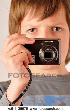 Stock Photograph - Young boy with a camera. Fotosearch