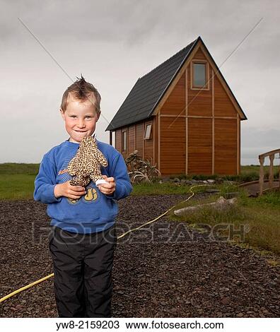 Stock Image - Young boy with a stuffed toy, Iceland.. Fotosearch