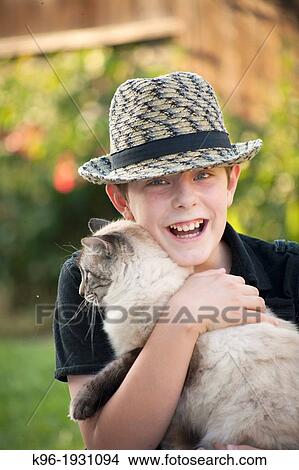 Young boy with cat View Large Photo Image Picture - Young boy with cat. Fotosearch