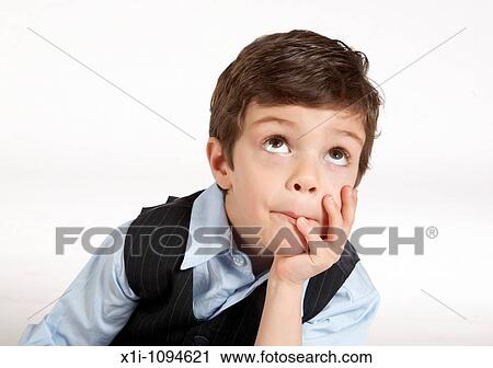 Young boy with hand on chin View Large Photo Image Stock Image - Young boy with hand on chin. Fotosearch
