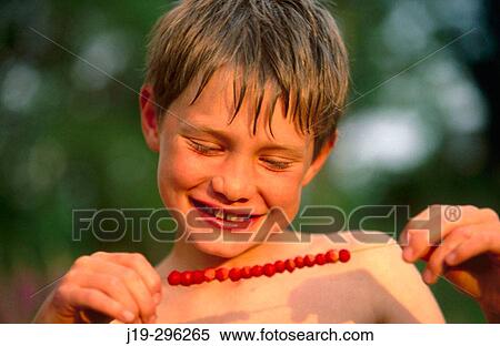 Young boy with wild strawberries on a straw in Swedish summer View Large Photo Image Stock Photography - Young boy with wild strawberries on a straw in Swedish summer. Fotosearch