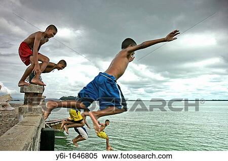 Young boys leap from pier Ko Sukorn island Thailand View Large Photo Image Stock Photography - Young boys leap from pier Ko Sukorn island Thailand. Fotosearch