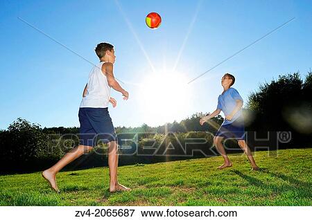 Young boys playing soccer on a meadow, Germany. View Large Photo Image Stock Photo - Young boys playing soccer on a meadow, Germany.. Fotosearch