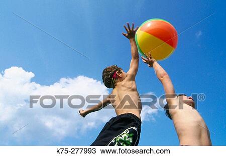 young boys playing with a beach ball View Large Photo Image Stock Image - young boys playing with a beach ball. Fotosearch