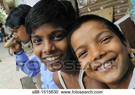 Young boys sitting on the backstreet tea shop bench View Large Photo Image Stock Image - Young boys sitting on the backstreet tea shop bench. Fotosearch