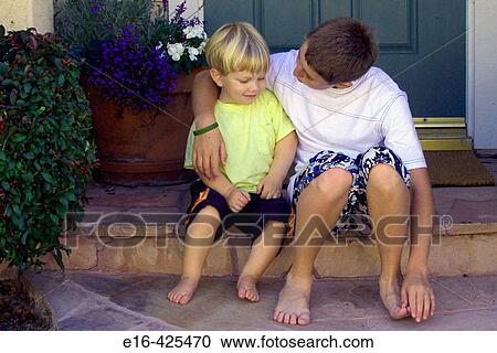 Stock Image - Young boys talking together. Fotosearch