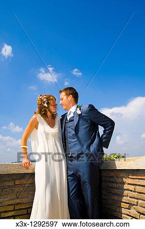 Young bride and groom standing on terrace in Rome, Italy View Large Photo Image Stock Photo - Young bride and groom standing on terrace in Rome, Italy. Fotosearch