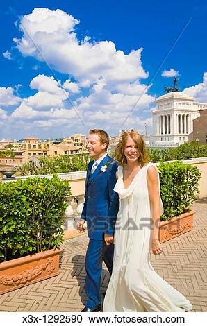 Young bride and groom walking in Rome, Italy View Large Photo Image Stock Image - Young bride and groom walking in Rome, Italy. Fotosearch