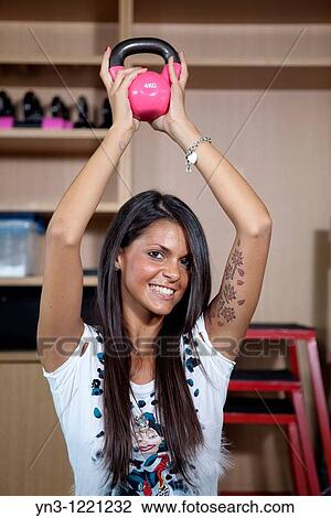 Young brunette lifting crossfit weights at the gym View Large Photo Image Stock Image - Young brunette lifting crossfit weights at the gym. Fotosearch