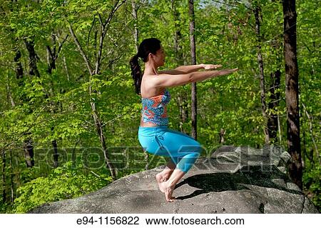 Young brunette woman doing yoga poses in a forest setting in the springtime. View Large Photo Image Stock Image - Young brunette woman doing yoga poses in a forest setting in the springtime.. Fotosearch
