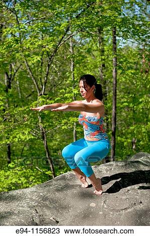 Young brunette woman doing yoga poses in a forest setting in the springtime. View Large Photo Image Stock Image - Young brunette woman doing yoga poses in a forest setting in the springtime.. Fotosearch