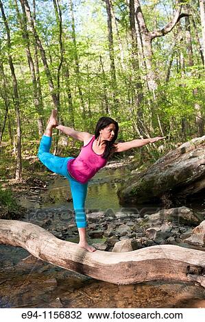 Young brunette woman doing yoga poses in a forest setting in the springtime. View Large Photo Image Stock Image - Young brunette woman doing yoga poses in a forest setting in the springtime.. Fotosearch