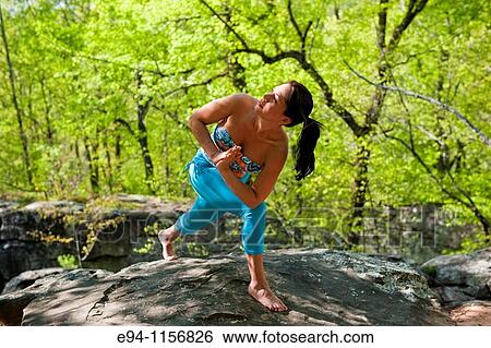 Young brunette woman doing yoga poses in a forest setting in the springtime. View Large Photo Image Stock Photograph - Young brunette woman doing yoga poses in a forest setting in the springtime.. Fotosearch