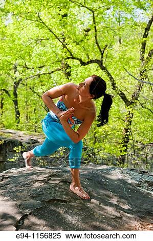 Young brunette woman doing yoga poses in a forest setting in the springtime. View Large Photo Image Stock Photography - Young brunette woman doing yoga poses in a forest setting in the springtime.. Fotosearch