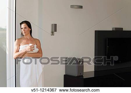 Young brunette woman enjoying a coffee and the views from the balcony View Large Photo Image Stock Photo - Young brunette woman enjoying a coffee and the views from the balcony. Fotosearch