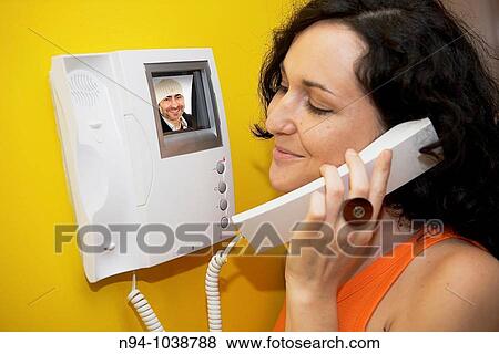 Young brunette woman, speaking by video entry. View Large Photo Image Stock Photo - Young brunette woman, speaking by video entry.. Fotosearch