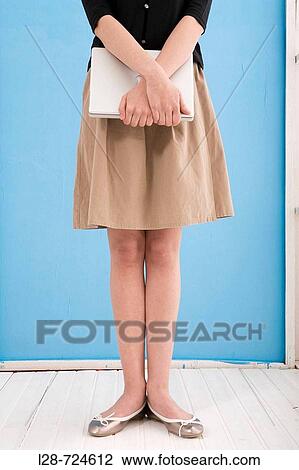 young business woman holding computer View Large Photo Image Stock Image - young business woman holding computer. Fotosearch