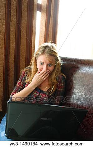 Picture - young business woman working on her laptop in a cafe. Fotosearch