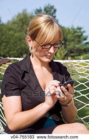 Young business woman writing a SMS View Large Photo Image Stock Image - Young business woman writing a SMS. Fotosearch