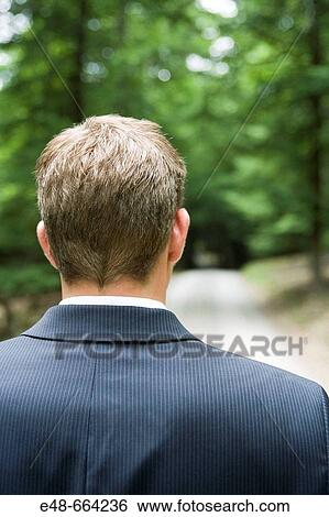 Young businessman in forest looking through binoculars View Large Photo Image Stock Photograph - Young businessman in forest looking through binoculars. Fotosearch