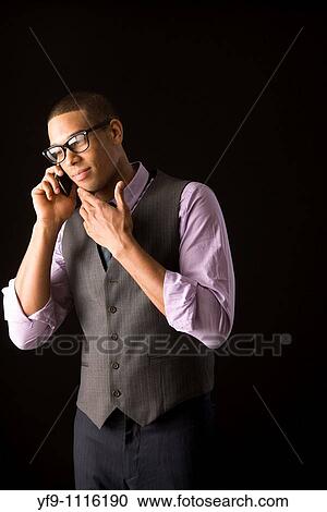 Young businessman talking on cell phone. View Large Photo Image Stock Image - Young businessman talking on cell phone.. Fotosearch