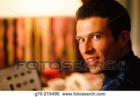 Stock Image - Young businessman working on computer. Fotosearch