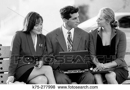 Stock Photo - young businesspeople with wireless laptop. Fotosearch