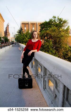 Stock Photo - Young businesswoman of Russian descent in Spokane, Washington, USA, standing on the Monroe Street Bridge in downtown.. Fotosearch