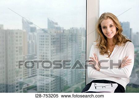 Young businesswoman sitting and relax near window View Large Photo Image Stock Photography - Young businesswoman sitting and relax near window. Fotosearch