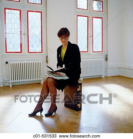Young businesswoman with black dress sitting in empty room View Large Photo Image Stock Image - Young businesswoman with black dress sitting in empty room. Fotosearch