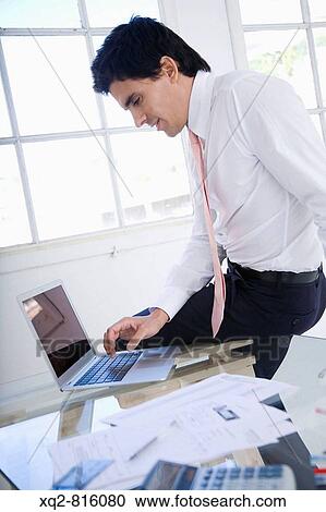 Young bussinessman at office View Large Photo Image Stock Image - Young bussinessman at office. Fotosearch