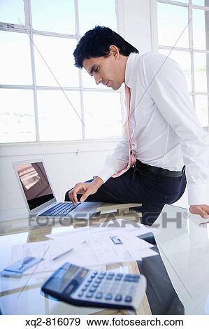 Young bussinessman at office View Large Photo Image Stock Photo - Young bussinessman at office. Fotosearch