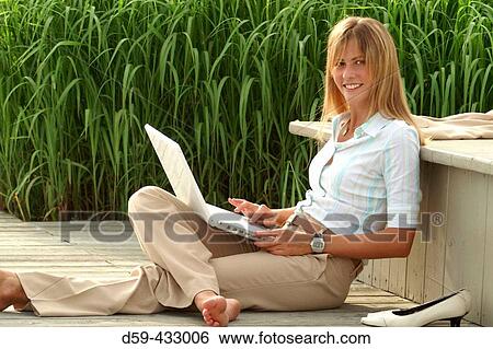 Young career woman, taking a break, with laptop computer. View Large Photo Image Stock Photograph - Young career woman, taking a break, with laptop computer.. Fotosearch