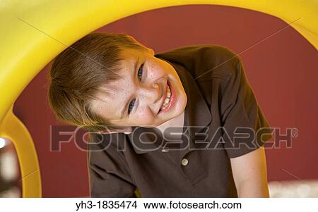 Young Caucasian boy having fun playing at the playground View Large Photo Image Picture - Young Caucasian boy having fun playing at the playground. Fotosearch