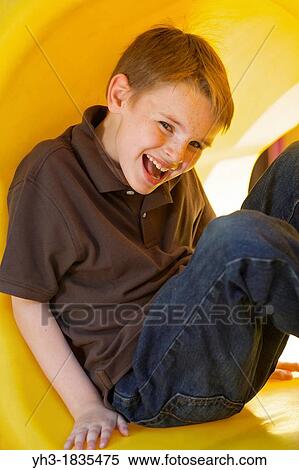 Young Caucasian boy having fun playing at the playground View Large Photo Image Stock Photography - Young Caucasian boy having fun playing at the playground. Fotosearch
